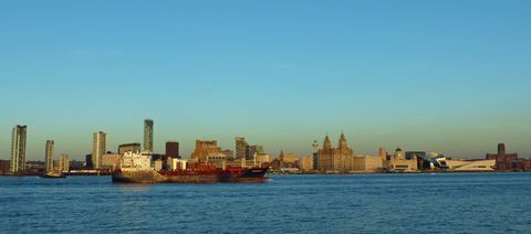 The Liverpool waterfront skyline across the River Mersey at golden hour
